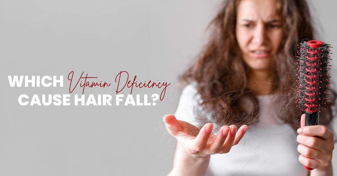 Woman experiencing hair loss holding a brush with hair, illustrating the question of which vitamin deficiency causes hair fall