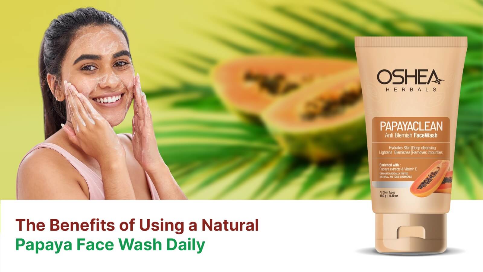 Smiling woman applying papaya face wash, papaya fruit and tube of anti-blemish face wash.