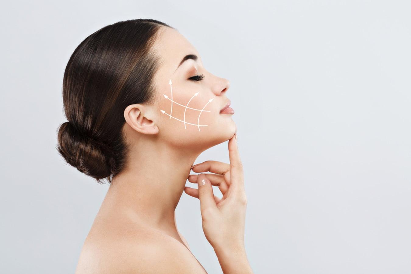 Woman with smooth skin and drawn arrows on cheek showing facial lifting, anti-aging skincare concept