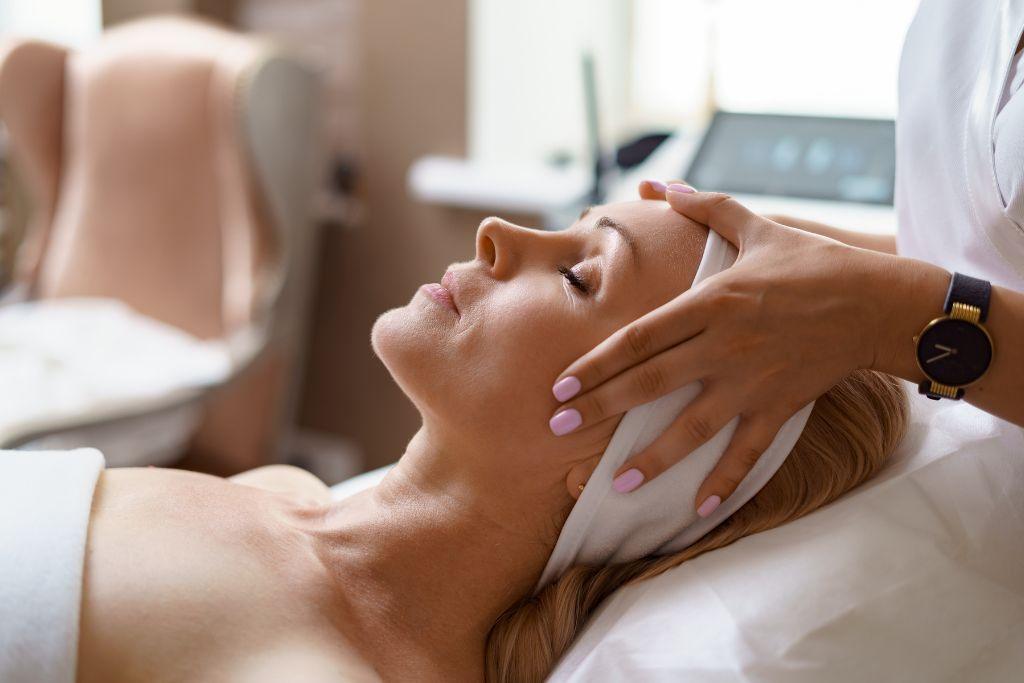 Woman receiving relaxing diamond facial treatment at spa, skincare and beauty therapy